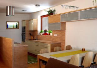 Kuchyně navazující na obývací pokoj v laku vysoký lesk a dubu Winchester. Výklenek prosvětluje sousedící spíž.